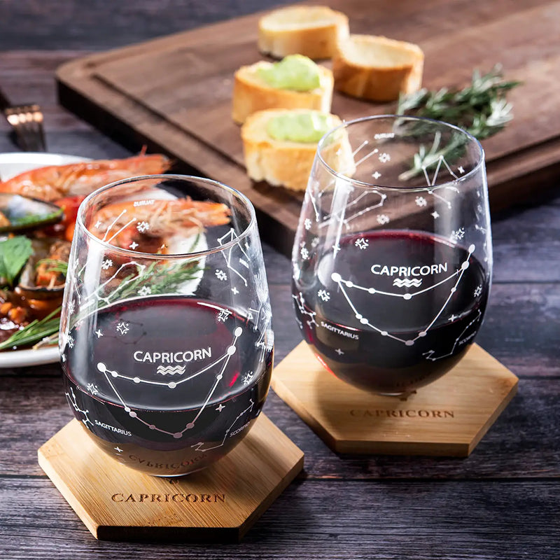 Set of 2 Zodiac Sign Wine Glasses with 2 Wooden Coasters by The Wine Savant - Astrology Drinking Glass Set with Etched Constellation Tumblers for Juice, Water Home Bar Horoscope Gifts 18oz (Capricorn)